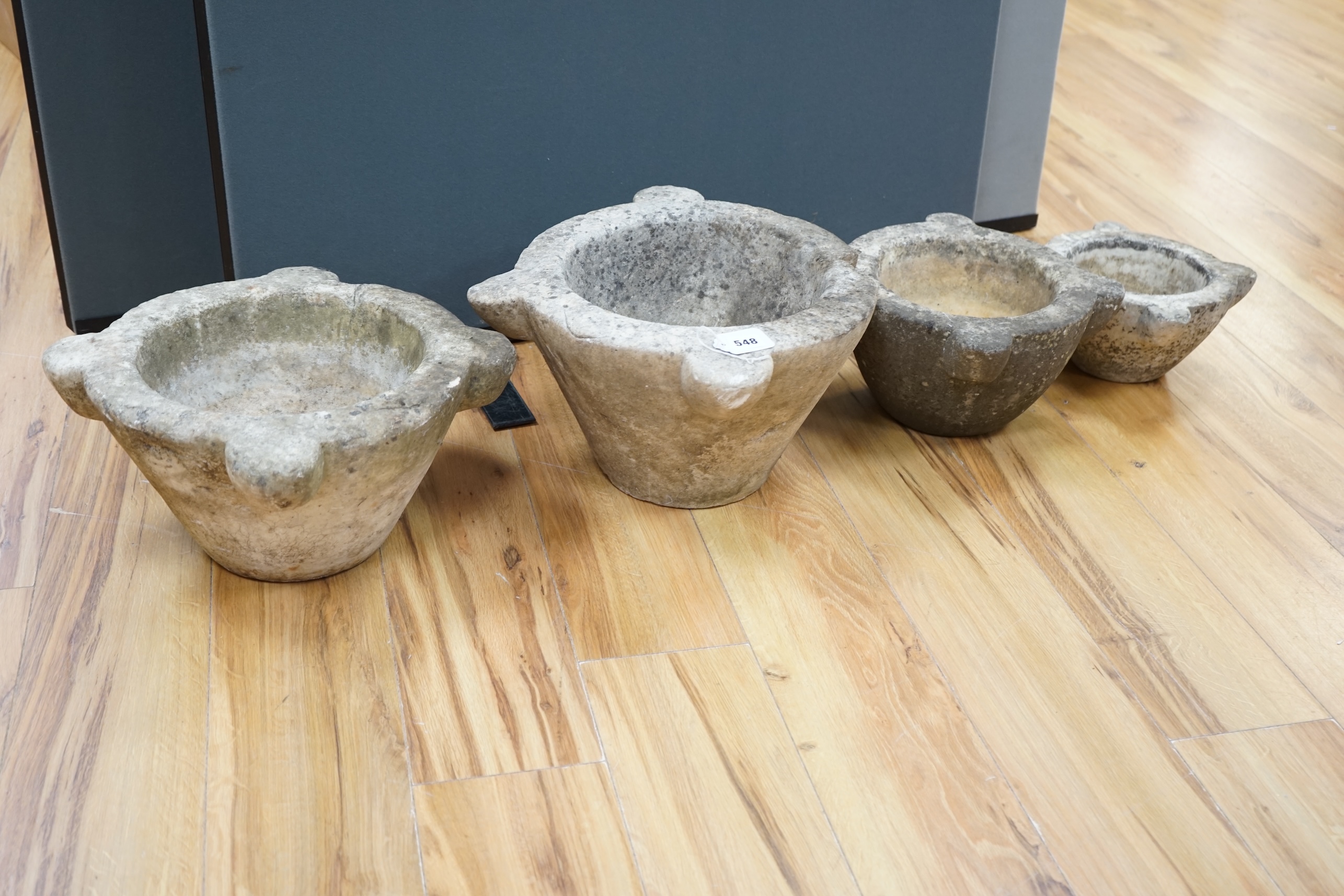 Four graduated marble mortars, largest 46.5cm wide across top rim. Condition - largest mortar has a handle missing, all have been stored outside and are marked